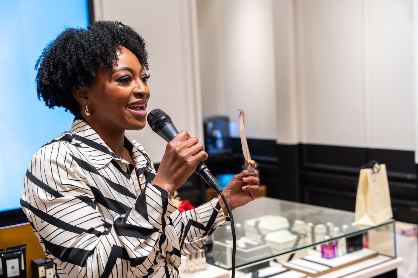 Dammy speaking into a microphone at the Jo Malone London event